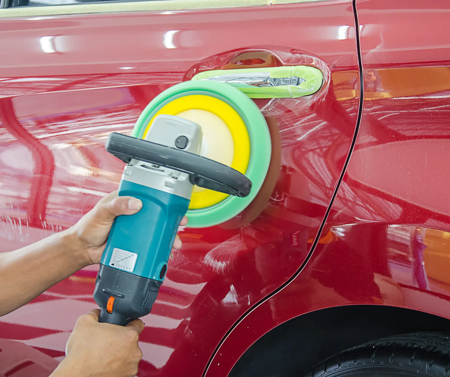 Close-up of a high-gloss buffed finish on a red body panel